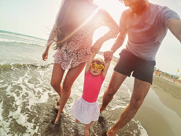 istock Crazy smiling family with sunglasses on beach 544558502
