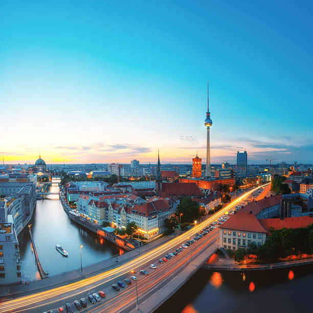 Skyline Of Berlin in Germany with TV Tower, Berlin Town Hall and a busy street in the evening