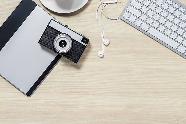 istock Top view of photo camera lying on the table 544562432