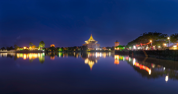 Panorama view of Kuching Waterfront, The Sarawak State Legislative Assembly Building and Astana during blue hour.