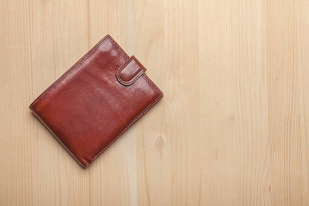 istock brown leather wallet on wooden table 544562918