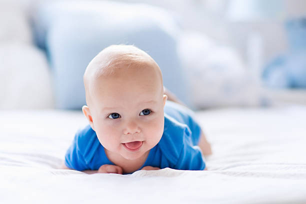istock Baby boy in white sunny bedroom 544563320