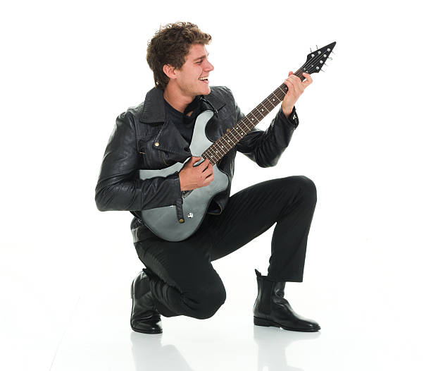 istock Cheerful man crouching and playing guitar 544563444