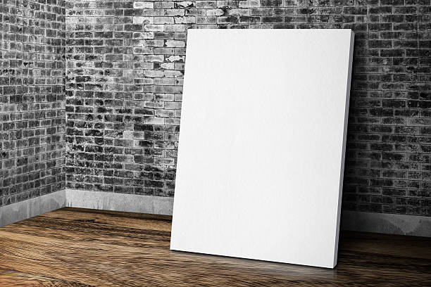 istock Blank canvas frame leaning at grunge brick wall and wood 544564986