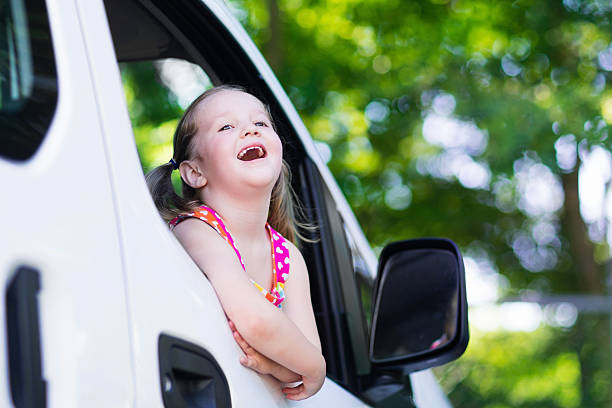istock Little girl sitting in white car 544565372