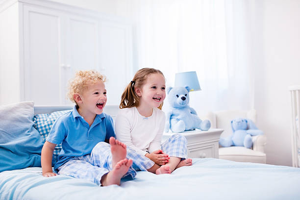 istock Kids playing in white bedroom 544566078