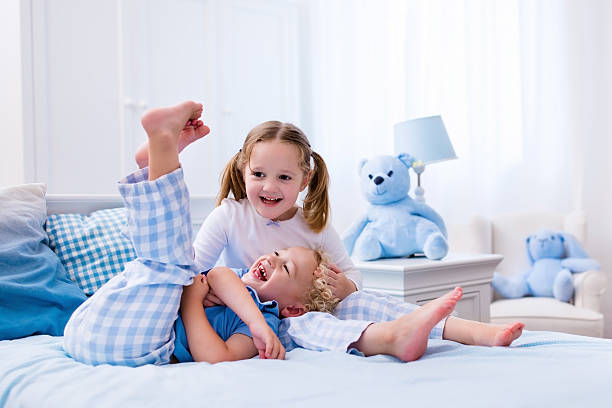 istock Happy kids playing in white bedroom 544566250