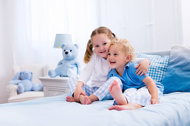 istock Little happy kids playing in white bedroom 544566424