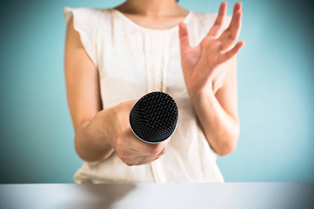 istock Asian woman holding microphone 544566468