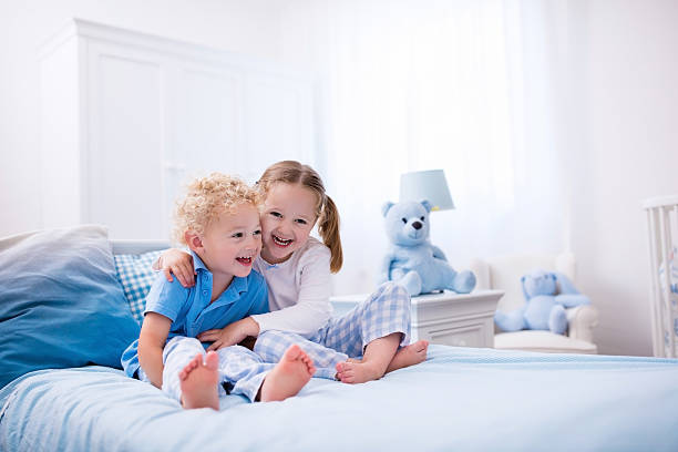istock Children playing in white bedroom 544566570