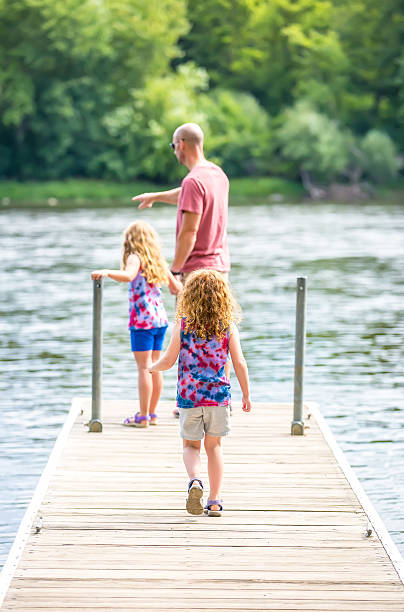 istock Two Young Girls & Dad On Mississippi River Dock 544566650