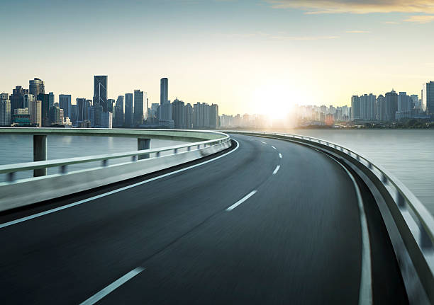istock Highway overpass motion blur with city skyline background . 544567346