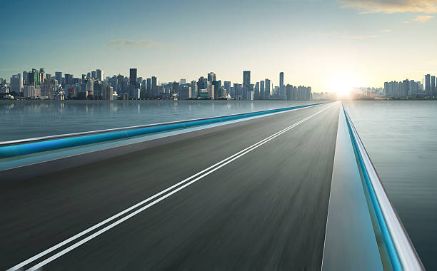 istock Highway overpass motion blur with city skyline background . 544567382