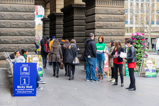 Melbourne, Australia - July 2, 2016: View of electors going to vote for federal election on the polling day while volunteers handing out pamphlets at Melbourne Town Hall.