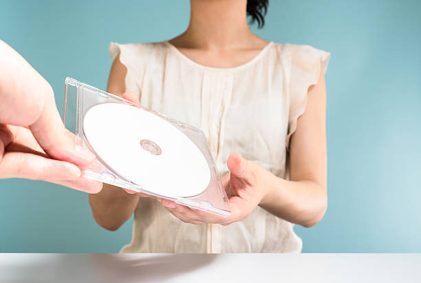 istock Asian woman passed DVD-rom by colleague 544568646