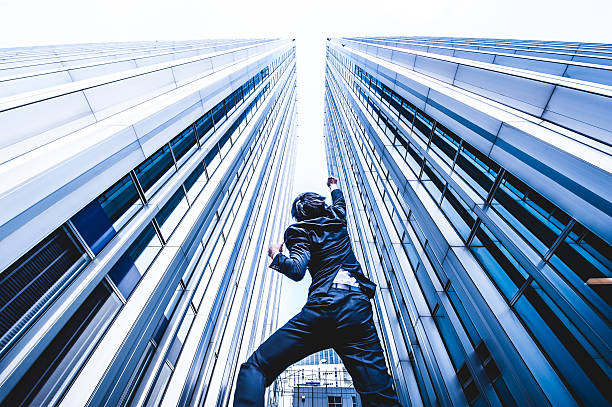 istock Businessman looking up at the high building, low angle 544569992