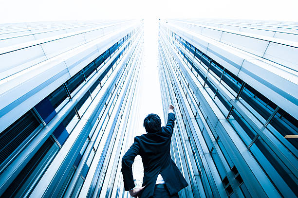 istock Businessman looking up at the high building, low angle 544570006
