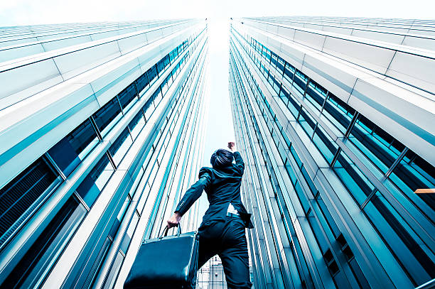 istock Businessman looking up at the high building, low angle 544570030