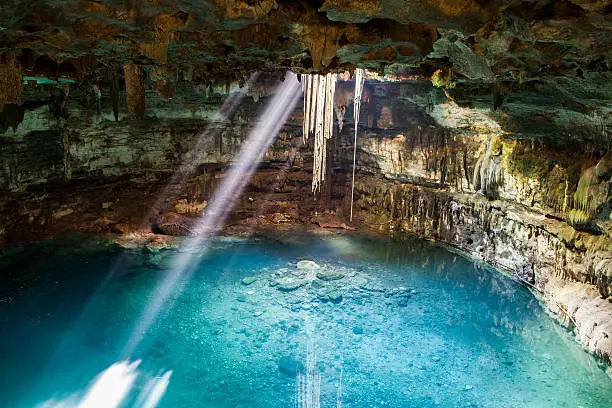 Sambula cenote is a beautiful underground cavern that will surprise you with its natural beauty and the breadth of the place. Its crystal clear turquoise blue are illuminated through a hole in the top of the cave where you can admire as the hanging roots of a tree has been cut into the surface but that is still alive because it follows the water feeding, admired the fish that live in and see clearly where their bottoms and deep here you can safely enjoy this cool and underground cenote.