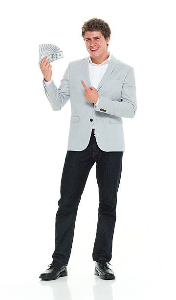 istock Smiling smart casual man pointing at money 544571918