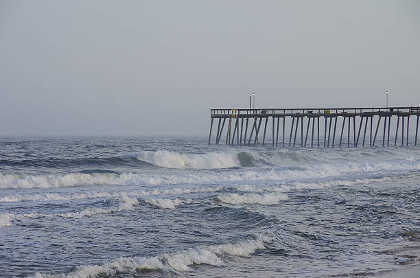 istock Waves crash on the pier on a stormy evening 544572418