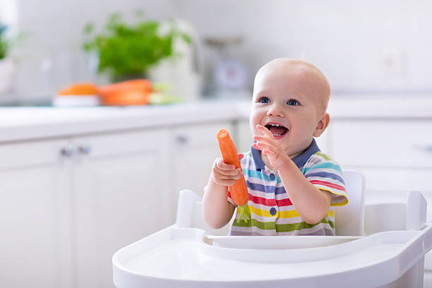 istock Little baby eating carrot 544572440