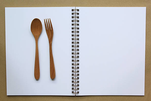 istock Empty paper for recipe with wooden cooking utensils. 544573422