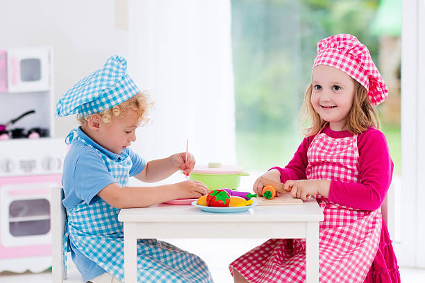 istock Funny kids playing with toy kitchen 544574104