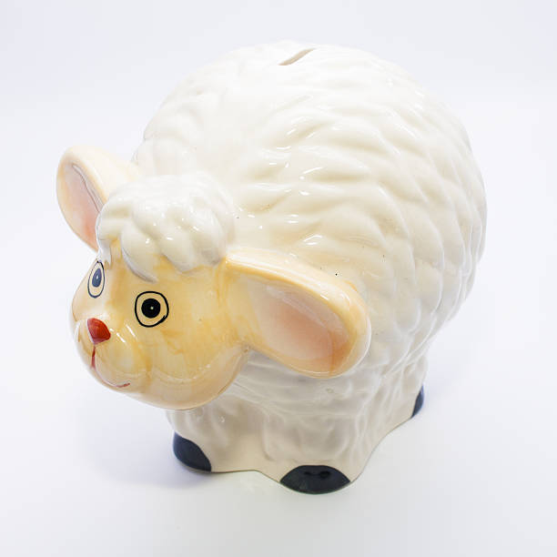 istock Ceramic sheep on a white background, piggy bank. 544576656