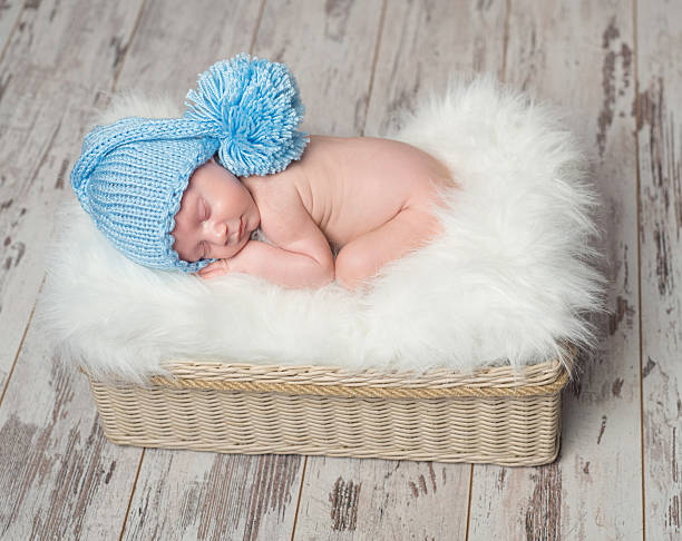 istock baby in blue hat sleeping on fluffy blanket 544578834