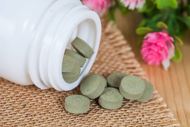 istock herb pill spilling out of a bottle 544581596