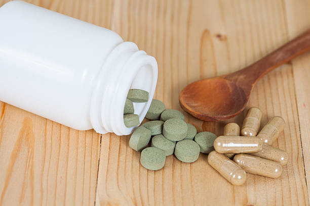 istock herb pill spilling out of a bottle 544581778