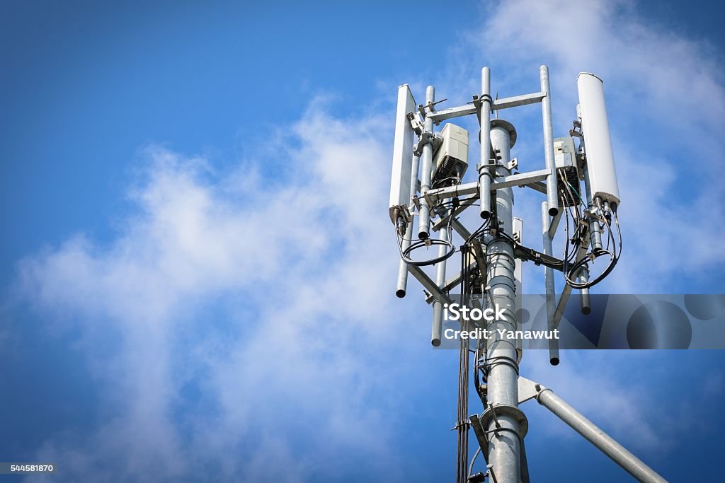 Telecommunications Tower Telecommunications Tower with antennas on blue sky with cloud Telecommunications Equipment Stock Photo