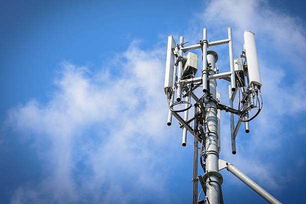 Telecommunications Tower Telecommunications Tower with antennas on blue sky with cloud mast stock pictures, royalty-free photos & images