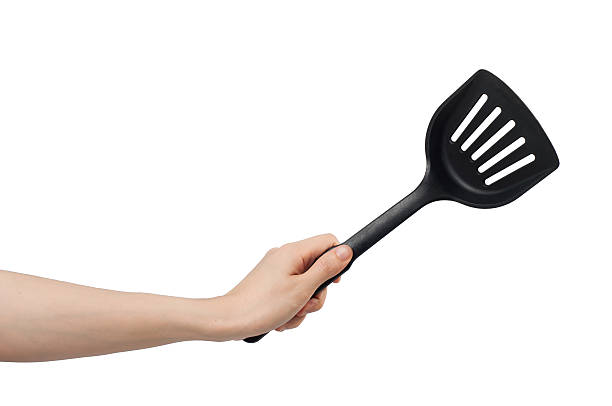 left hand holding spade of frying pan. left hand holding spade of frying pan on white background. left handed catcher stock pictures, royalty-free photos & images