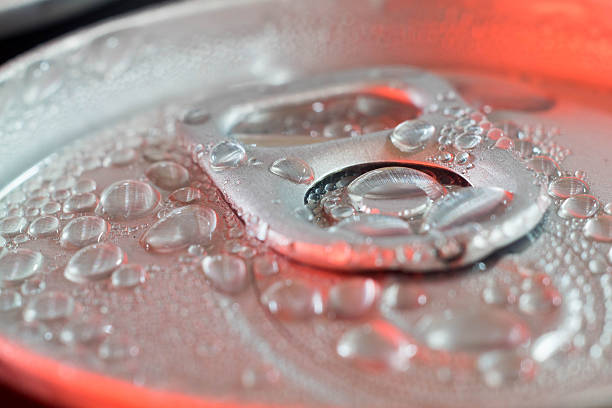 istock drops of water on pop can closeup in red light 544582772