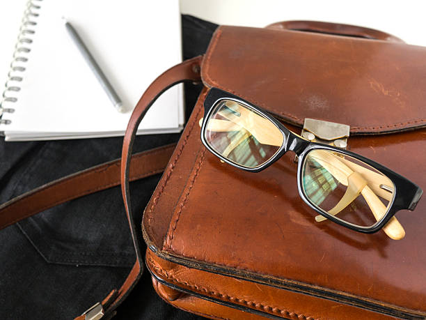 istock notebook  eye glasses pencil and leather bag on white background 544584438