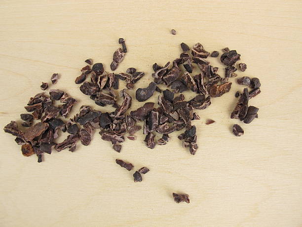 istock Cocoa nibs from raw cocoa beans on wooden board 544584874