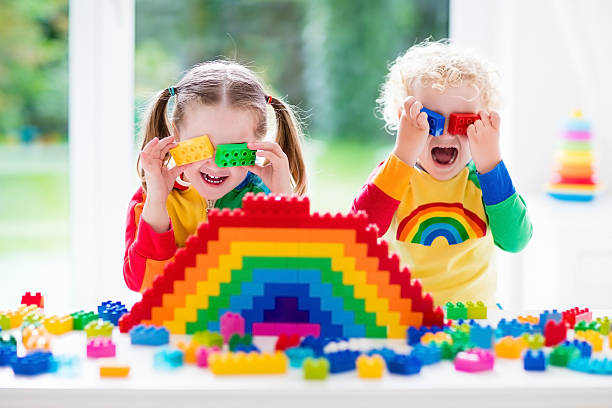 istock Kids playing with colorful blocks toys 544586432