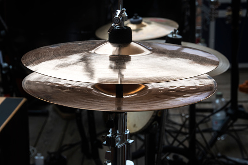 hi-hat on stage, combination cymbal in a percussion drum kit for pop, rock, jazz, folk music and more, dark ambient, selected focus, narrow depth of field
