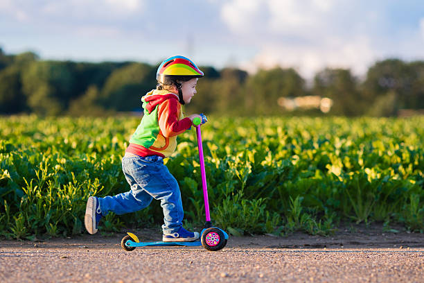 istock Little boy riding a colorful scooter 544587728