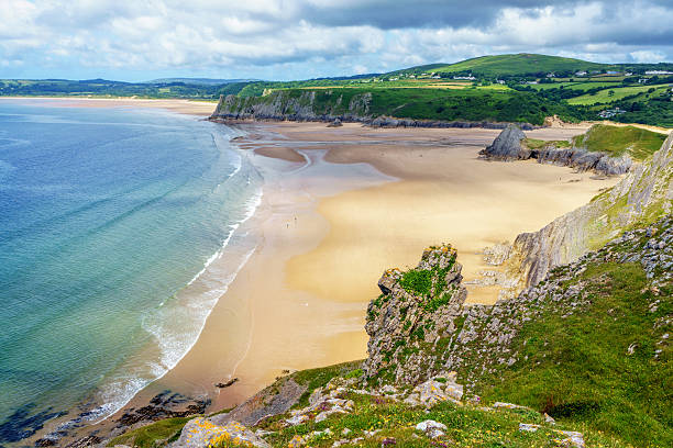 Three Cliffs Bay on Gower Three Cliffs Bay on Gower gower peninsular stock pictures, royalty-free photos & images