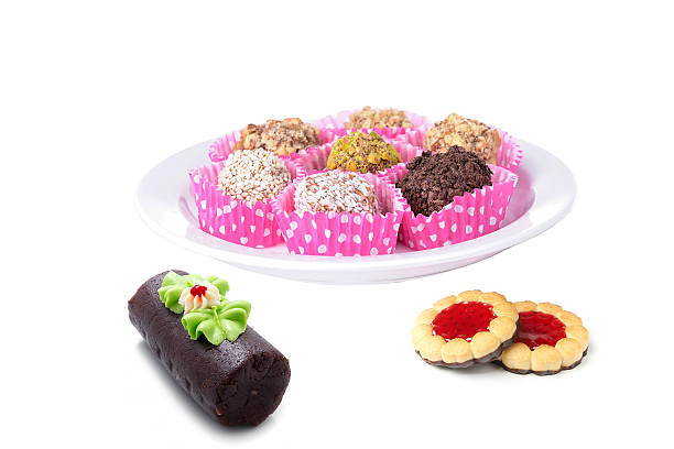 Plate of cakes, biscuits and sweets isolated on white.