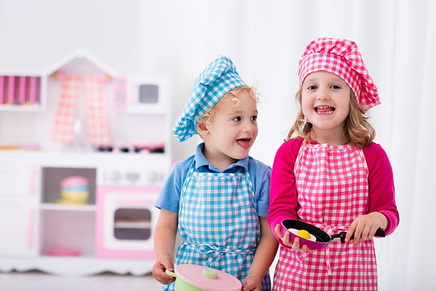 istock Little kids playing with toy kitchen 544591156