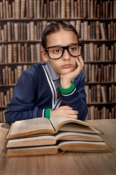 istock young boy with eye glasses or genius in library 544593048