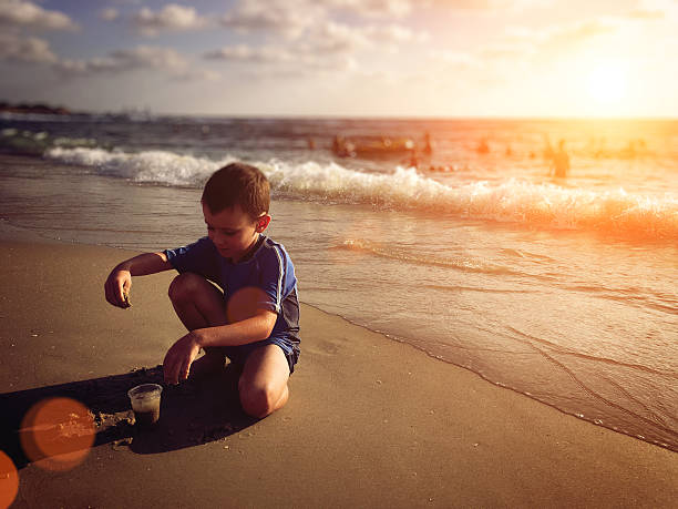 istock Summer vacation boy child play on sea beach concept 544593266