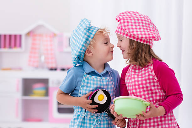 istock Kids playing with toy kitchen cooking eggs 544593650