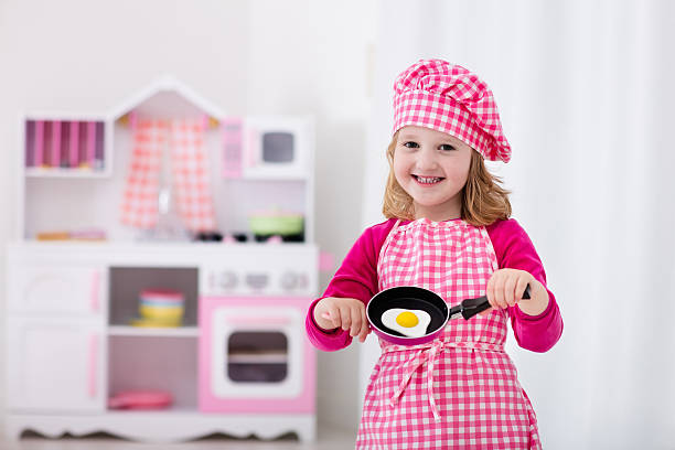 istock Little girl playing with toy kitchen 544594240