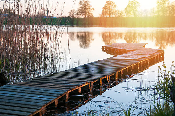 istock Wooden jetty on lake under the sunset 544595148