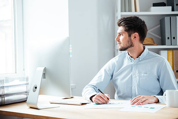 istock Pensive businessman sitting with laptop at office 544595918